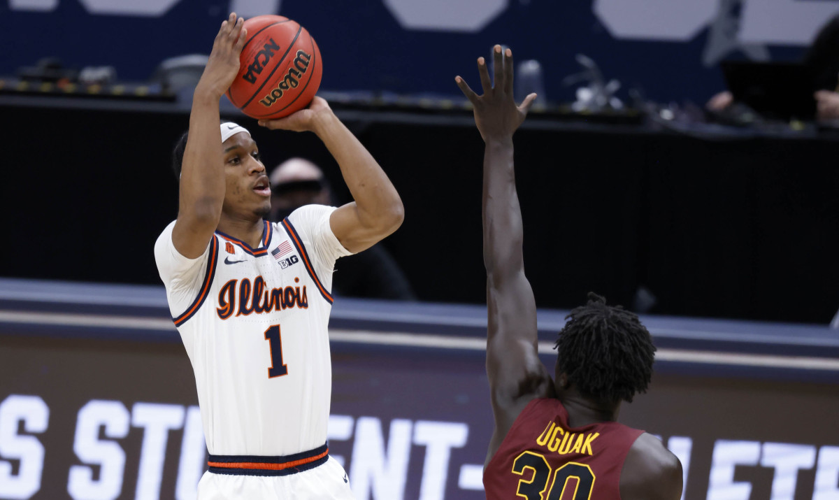 Illinois Fighting Illini guard Trent Frazier (1) takes a shot as Loyola (Il) Ramblers forward Aher Uguak (30) attempts a block during the second round of the 2021 NCAA Tournament on Sunday, March 21, 2021, at Bankers Life Fieldhouse in Indianapolis, Ind.